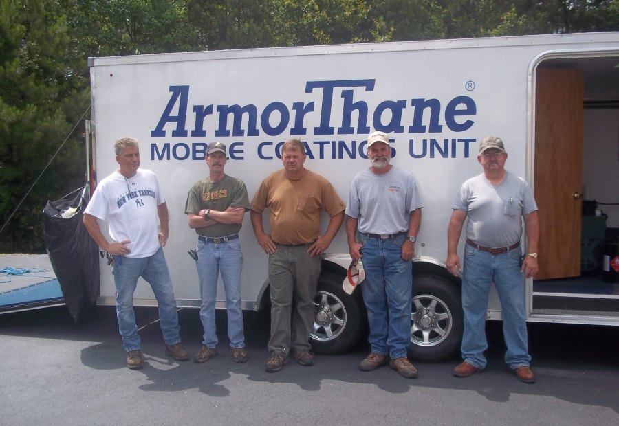 A training class lined up in front of the ArmorThane Mobile Coatings Unit
