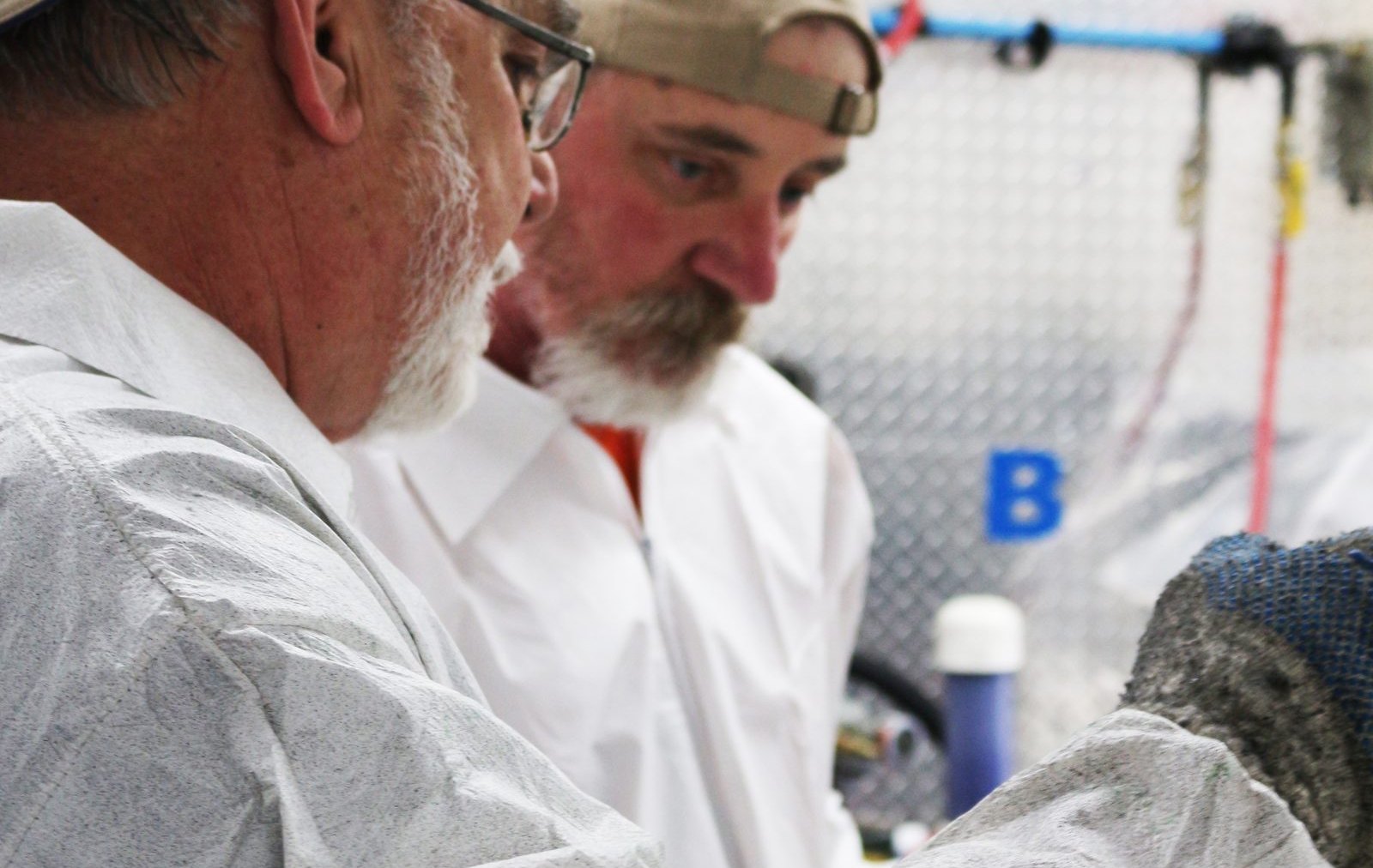 Instructor pointing out the B-side plumbing on a proportioner to a trainee