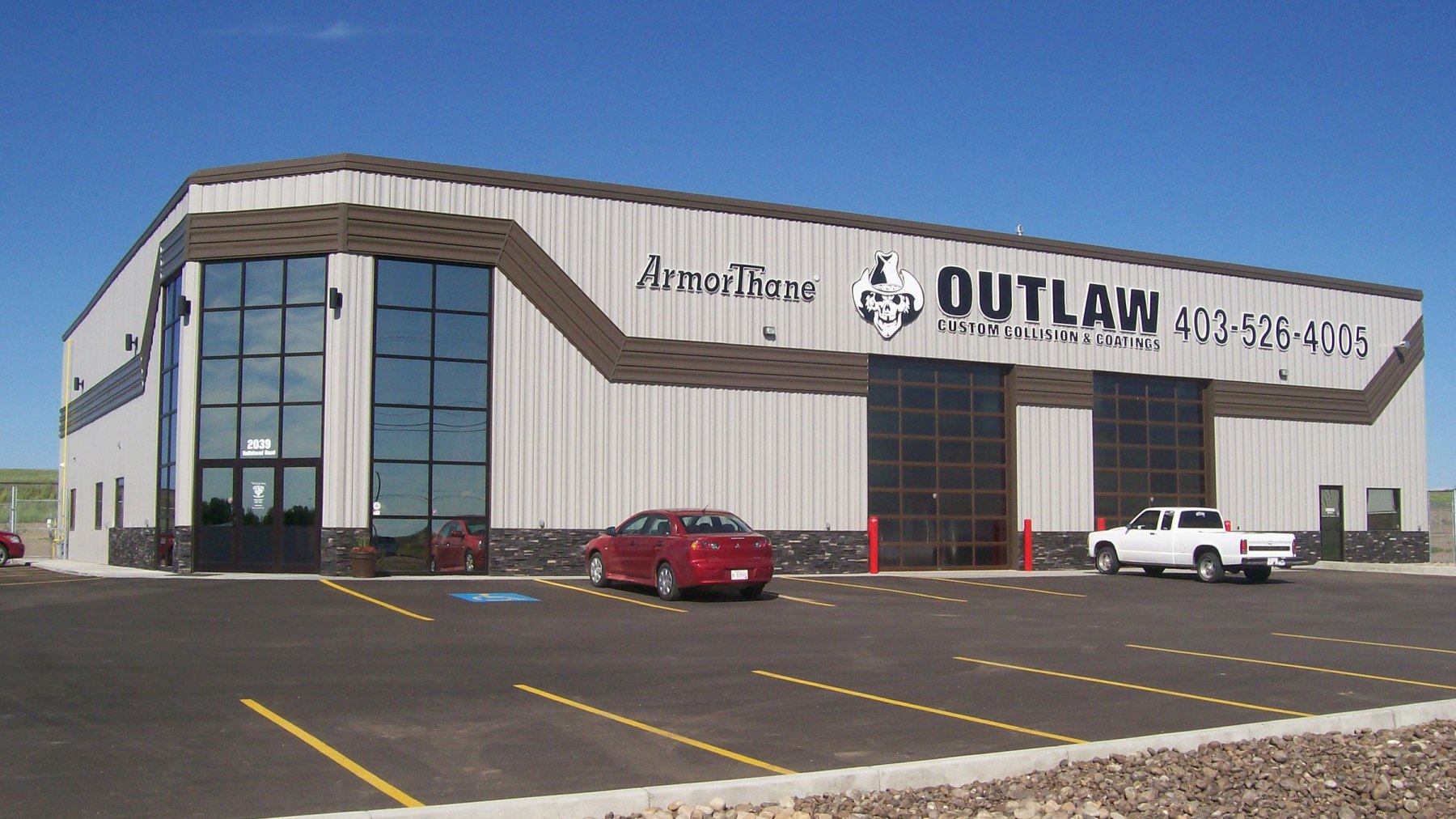 Exterior of an ArmorThane training and coatings facility on a clear day