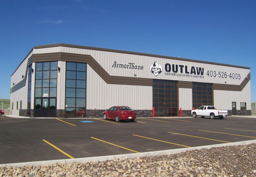 Exterior of an ArmorThane training and coatings facility on a clear day