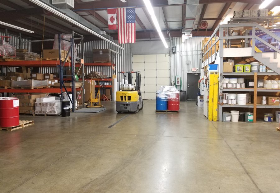 Warehouse aisle lined with coating stock and equipment