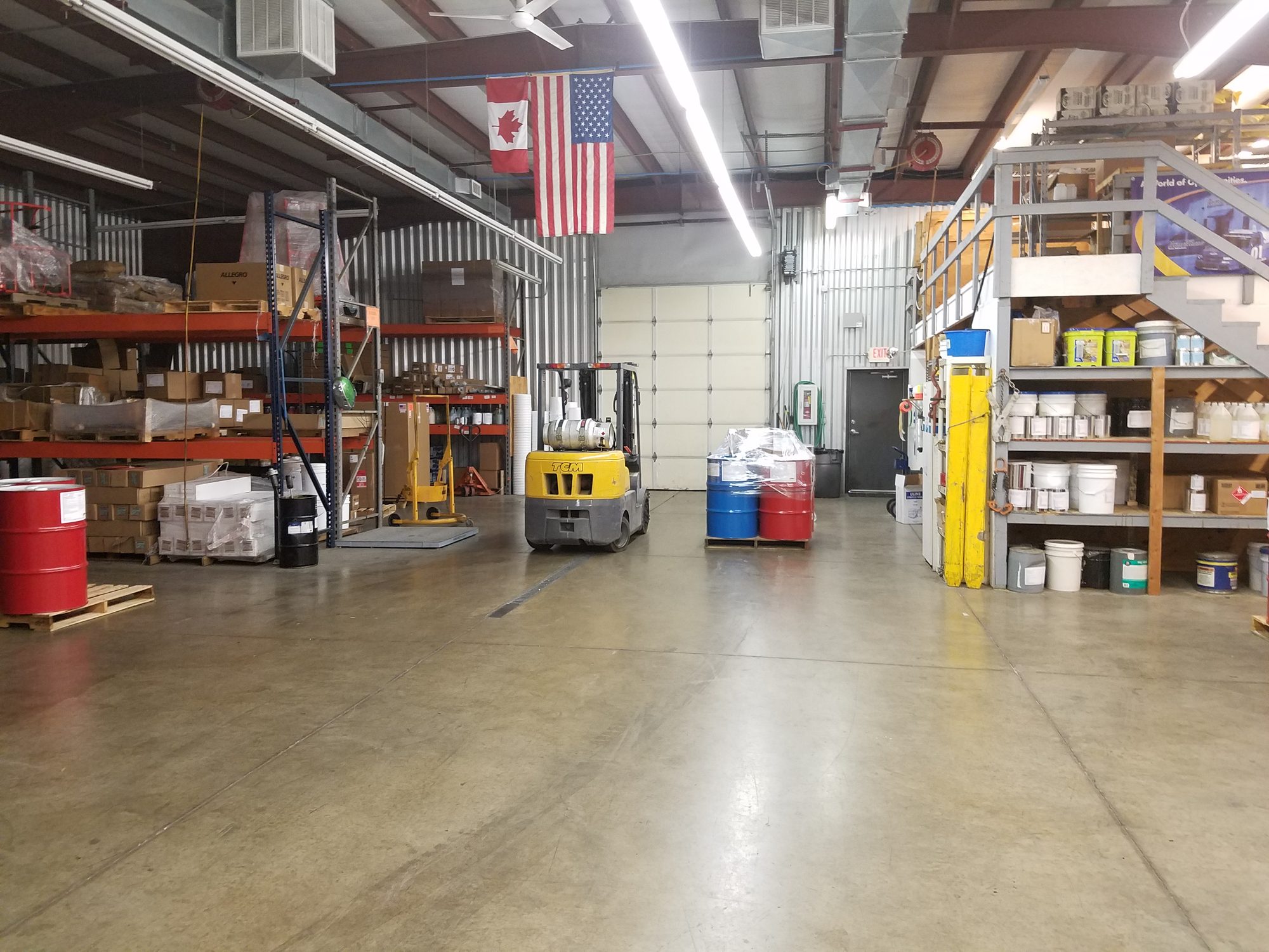 Warehouse aisle lined with coating stock and equipment